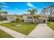 Lush landscaping surrounds this waterfront home with barrel tile roof and circular tower at 2005 N Pointe Alexis Dr, Tarpon Springs, FL 34689