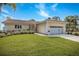 Charming single-story home with a well-manicured lawn, complemented by lush landscaping and a two-car garage at 2005 N Pointe Alexis Dr, Tarpon Springs, FL 34689