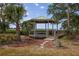 Charming gazebo surrounded by lush greenery, offering a serene spot to relax and enjoy nature's beauty at 2005 N Pointe Alexis Dr, Tarpon Springs, FL 34689