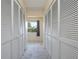 Hallway with closet space on both sides and a window at the end of the hall at 2005 N Pointe Alexis Dr, Tarpon Springs, FL 34689
