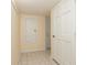 Bright hallway with tiled floor, featuring a closet and access to other rooms within the home at 2005 N Pointe Alexis Dr, Tarpon Springs, FL 34689