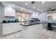 Bright kitchen boasts white cabinetry, black countertops and stainless steel appliances at 2005 N Pointe Alexis Dr, Tarpon Springs, FL 34689