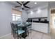 Kitchen dining area features a table with turquoise chairs, white cabinetry, and a ceiling fan at 2005 N Pointe Alexis Dr, Tarpon Springs, FL 34689