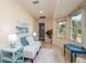 Bright sunroom featuring travertine floors, large windows, comfortable seating, and serene decor at 2005 N Pointe Alexis Dr, Tarpon Springs, FL 34689