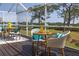 Outdoor patio with dining and seating area overlooking the water and lush greenery at 2005 N Pointe Alexis Dr, Tarpon Springs, FL 34689