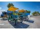 Unique four-person bikes with yellow canopies are ready for rent near the waterfront at 2005 N Pointe Alexis Dr, Tarpon Springs, FL 34689