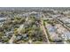 Overhead shot of a home in a neighborhood with tree-lined streets and nearby commercial areas at 217 2Nd Sw St, Largo, FL 33770