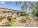 Spacious backyard featuring a brick patio, dining area, and lush landscaping at 217 2Nd Sw St, Largo, FL 33770