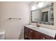Bathroom featuring a wood vanity with a white countertop and decorative mirror at 217 2Nd Sw St, Largo, FL 33770