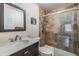 Bathroom featuring tiled shower with glass door, modern vanity, and updated fixtures at 217 2Nd Sw St, Largo, FL 33770