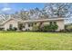 Beautiful single-story home featuring a lush green lawn and vibrant landscaping at 217 2Nd Sw St, Largo, FL 33770