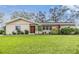 Inviting single-story home with a lush green lawn and well-maintained landscaping at 217 2Nd Sw St, Largo, FL 33770