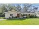 Charming single-story home with a lush green lawn and mature trees in a desirable neighborhood at 217 2Nd Sw St, Largo, FL 33770
