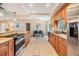 Spacious kitchen with granite countertops, stainless steel appliances, and an open dining area at 217 2Nd Sw St, Largo, FL 33770
