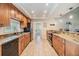 Light-filled kitchen with wood cabinets, granite countertops, stainless appliances, and laundry access at 217 2Nd Sw St, Largo, FL 33770