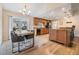 Well-lit kitchen and dining area with a breakfast bar, hardwood floors, and stainless steel appliances at 217 2Nd Sw St, Largo, FL 33770
