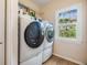 Convenient laundry room with modern washer and dryer, plus a view to the outside at 217 2Nd Sw St, Largo, FL 33770