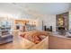 Open-concept living room with hardwood floors, a modern fireplace, and an adjacent kitchen and dining area at 217 2Nd Sw St, Largo, FL 33770