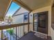 Private balcony offers outdoor space with railing, welcome mat, and glimpses of a lush landscape at 226 Woodlake Wynde, Oldsmar, FL 34677