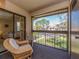 Cozy screened balcony with outdoor seating and views of the surrounding community at 226 Woodlake Wynde, Oldsmar, FL 34677