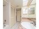 Bright bathroom with white tile, granite countertops, vanity, shower, and large closet at 226 Woodlake Wynde, Oldsmar, FL 34677
