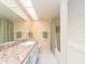 Bright bathroom featuring a cultured marble vanity, shower with curtain, and a large mirror at 226 Woodlake Wynde, Oldsmar, FL 34677