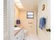 Well-lit bathroom featuring a vanity, walk-in shower, grab bar, and window at 226 Woodlake Wynde, Oldsmar, FL 34677