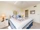 Bedroom boasts a ceiling fan, window, and a bed with starfish pillows and quilt at 226 Woodlake Wynde, Oldsmar, FL 34677
