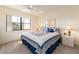 Bedroom with a ceiling fan, window, and a bed with starfish patterned pillows and quilt at 226 Woodlake Wynde, Oldsmar, FL 34677