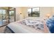 Bedroom showcasing a bed with decorative pillows, window, and private access to the screened balcony at 226 Woodlake Wynde, Oldsmar, FL 34677