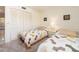 Bright bedroom features two twin beds, neutral carpeting, a closet, and a white bedside table at 226 Woodlake Wynde, Oldsmar, FL 34677