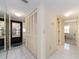 Bright hallway features tile flooring, closet, and a view of the patio through the glass door at 226 Woodlake Wynde, Oldsmar, FL 34677