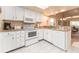 Well-lit kitchen features white cabinets and appliances, plus granite countertops at 226 Woodlake Wynde, Oldsmar, FL 34677
