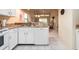 Kitchen includes bright white cabinets, tile flooring and granite countertops with views of the living area at 226 Woodlake Wynde, Oldsmar, FL 34677