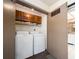 Convenient laundry closet with full-size washer and dryer, plus storage cabinets at 226 Woodlake Wynde, Oldsmar, FL 34677