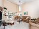 Inviting living room and dining area with vaulted ceilings and plentiful natural light from large windows at 226 Woodlake Wynde, Oldsmar, FL 34677
