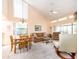 Open-concept living and dining area with high ceilings, carpeted floors, and sunlit windows at 226 Woodlake Wynde, Oldsmar, FL 34677