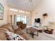 Comfortable living room with high ceilings, lots of windows, neutral carpet, and modern furnishings at 226 Woodlake Wynde, Oldsmar, FL 34677