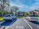 A view of two cars parked outside a condo building on a bright, sunny day at 226 Woodlake Wynde, Oldsmar, FL 34677