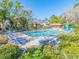 Beautiful community pool surrounded by lush greenery and lounge chairs, perfect for relaxation at 226 Woodlake Wynde, Oldsmar, FL 34677