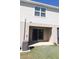 Backyard with a sliding glass door to the covered patio, an air conditioning unit, and green grass at 3032 Inlet Breeze Way, Holiday, FL 34691