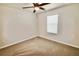 A bright bedroom with neutral walls, carpet flooring and a ceiling fan at 3032 Inlet Breeze Way, Holiday, FL 34691