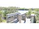 Wooden boardwalk with railings leading to a scenic view of water and greenery at 3032 Inlet Breeze Way, Holiday, FL 34691