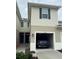Attached garage of the townhome with a car parked inside at 3032 Inlet Breeze Way, Holiday, FL 34691