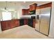Modern kitchen featuring stainless steel appliances, granite countertops, and tile flooring at 3032 Inlet Breeze Way, Holiday, FL 34691