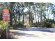 Entrance to Key Vista Nature Park with dirt path and direction signs at 3032 Inlet Breeze Way, Holiday, FL 34691