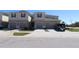Street view of a townhome with attached garages and well-manicured landscaping at 3032 Inlet Breeze Way, Holiday, FL 34691