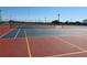Community tennis courts featuring a colorful painted surface and net, perfect for friendly matches at 3032 Inlet Breeze Way, Holiday, FL 34691