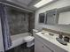 Well-lit bathroom featuring modern fixtures, tiled walls, and contemporary vanity at 3136 Primrose Dr, Holiday, FL 34691