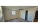 A simple bedroom has wood-look flooring, closet, and ceiling fan at 3136 Primrose Dr, Holiday, FL 34691